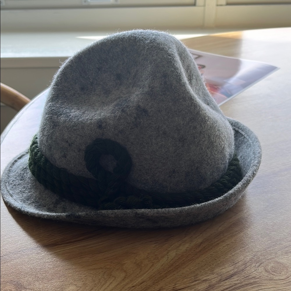 Gray (boiled wool hat)feature green braided band.